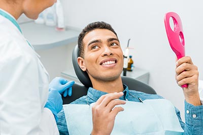 cosmetic dentist talking with patient