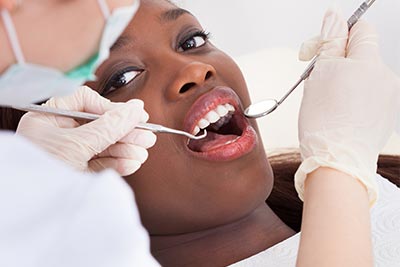 patient receiving a checkup covered by her dental discount plan
