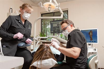 Dr. Zubkov looking at a patient's teeth