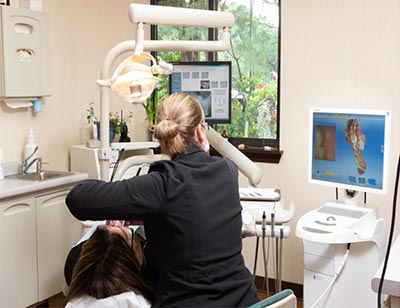 dentist cleaning patient's teeth