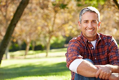 patient with new dental crowns smiling