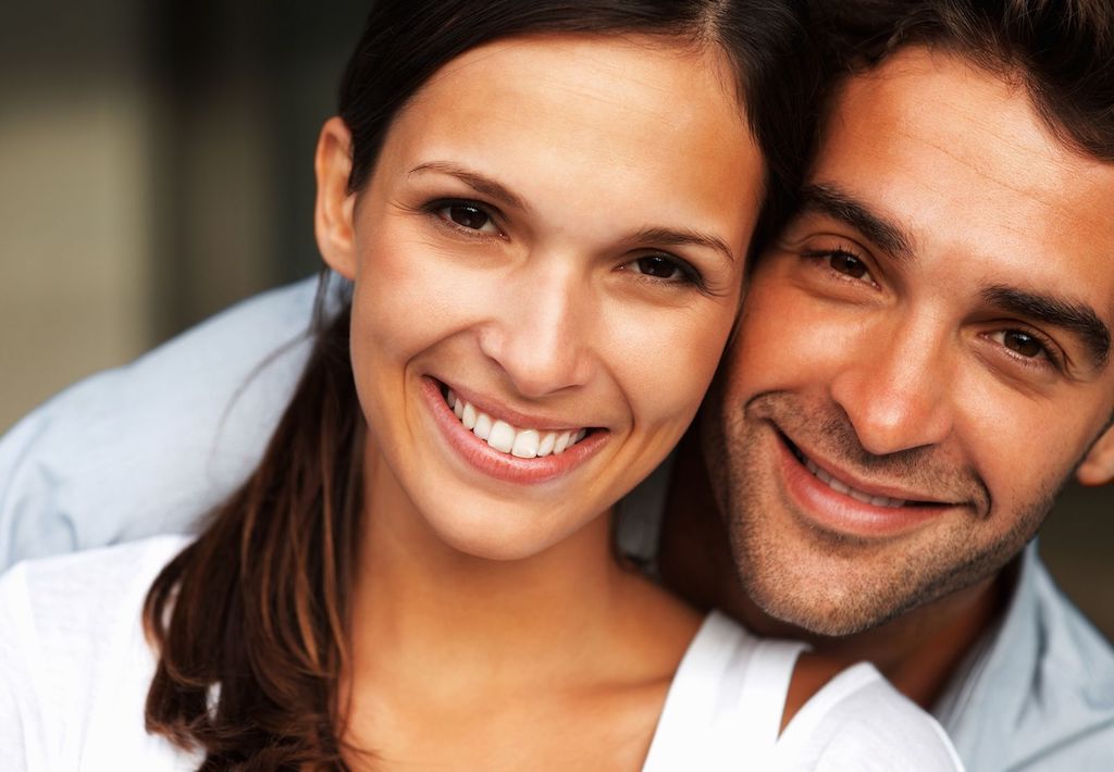woman smiling with boyfriend after root canal therapy in Enfield, CT